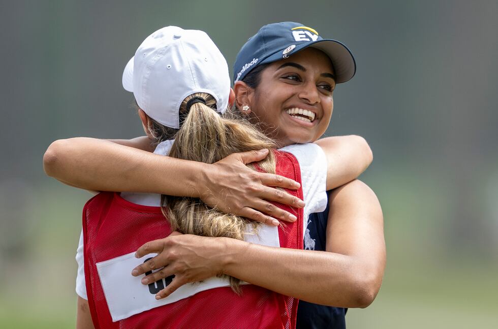 Megha Ganne of United States is congratulated by the her caddie Brooke Riley after scoring a...