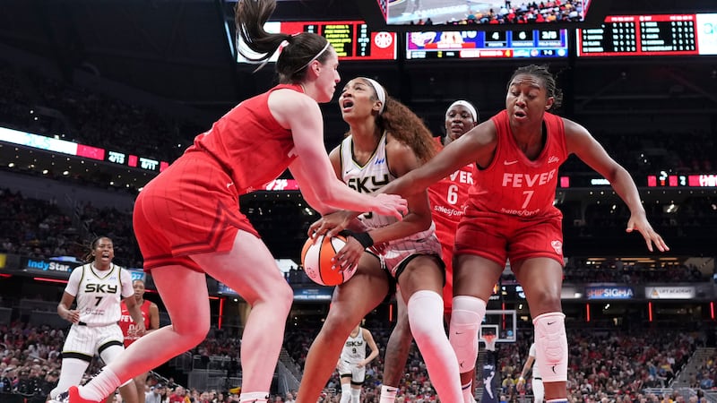 Indiana Fever guard Caitlin Clark, left, fouls Chicago Sky forward Angel Reese, center, during...