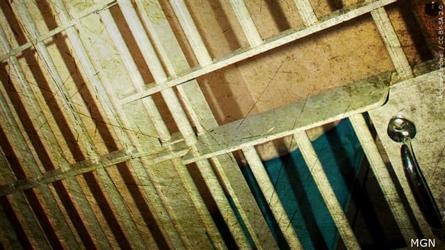 FILE - Jail bars