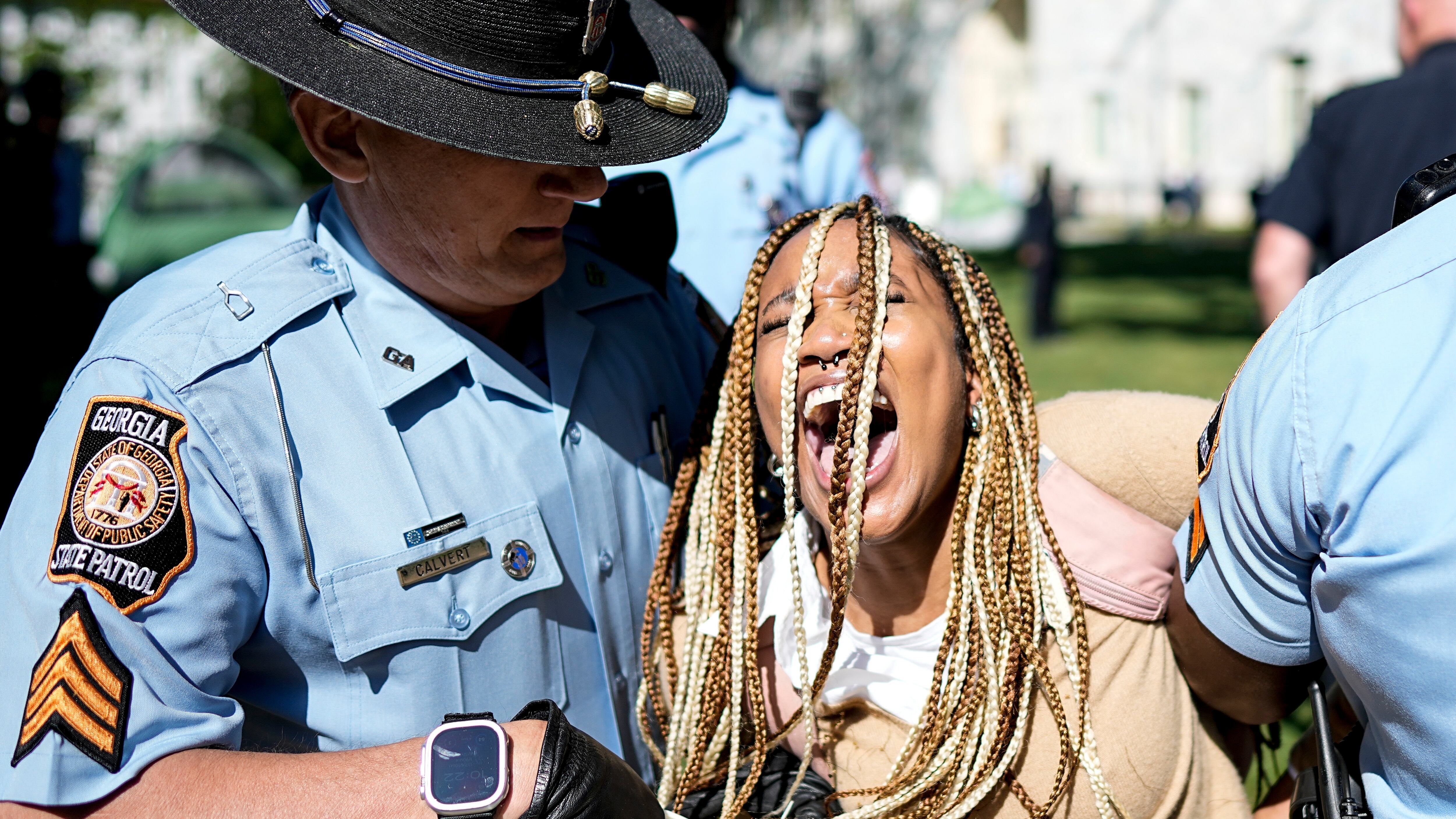 Georgia State Patrol officers detain a demonstrator on the campus of Emory Univeristy during a...