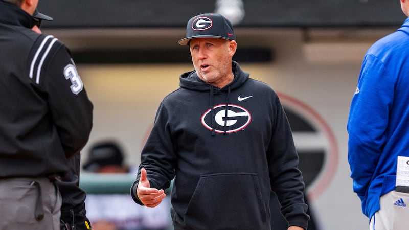 Georgia Head Coach Wes Johnson meets with umpire crew and UNC Asheville Head Coach Scott...