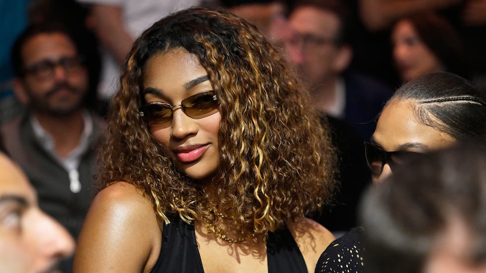 WNBA basketbal player Angel Reese sits at ringside during a super welterweight boxing match...