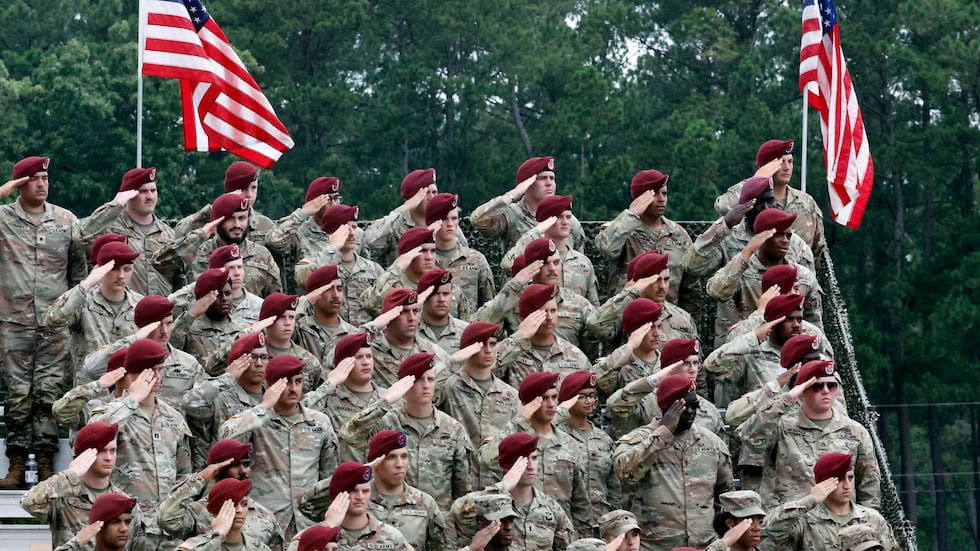 Soldiers of Fort Bragg stand in salute during the playing of the national anthem at The...