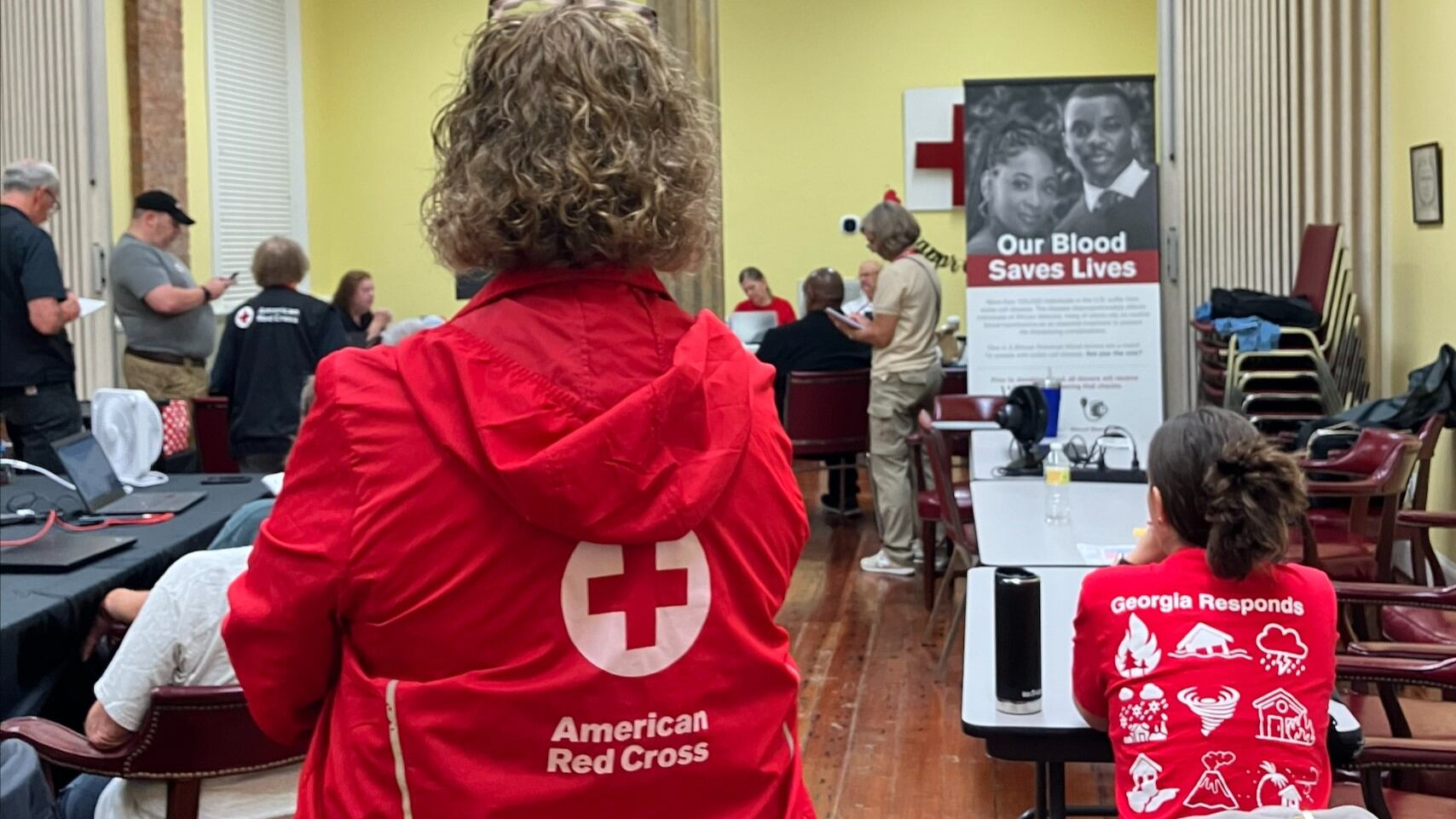Red Cross volunteers in Augusta gather for a meeting on Aug. 6, 2024, before going oiut to...
