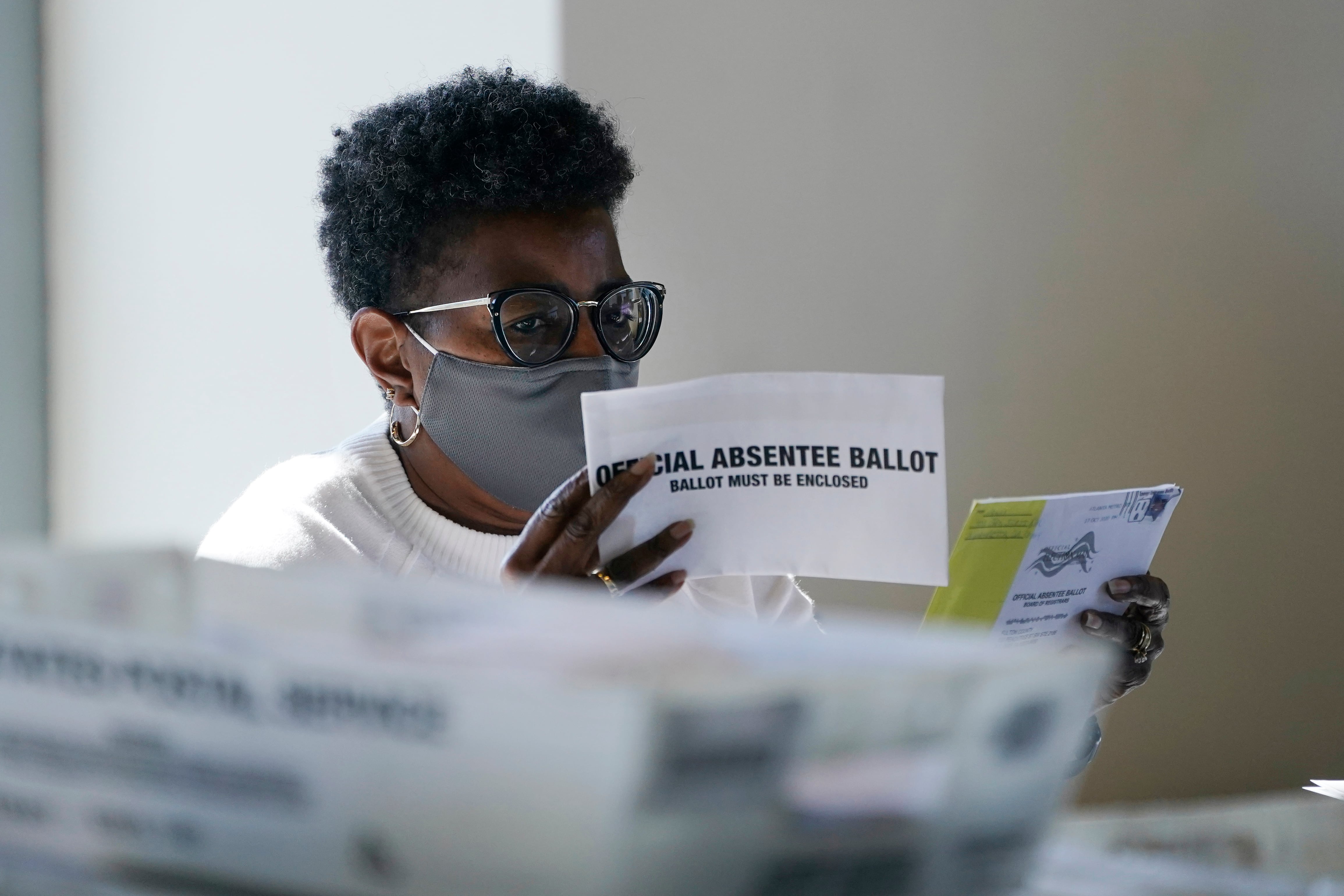 A worker at the Fulton County Board of Registration and Elections works to process absentee...