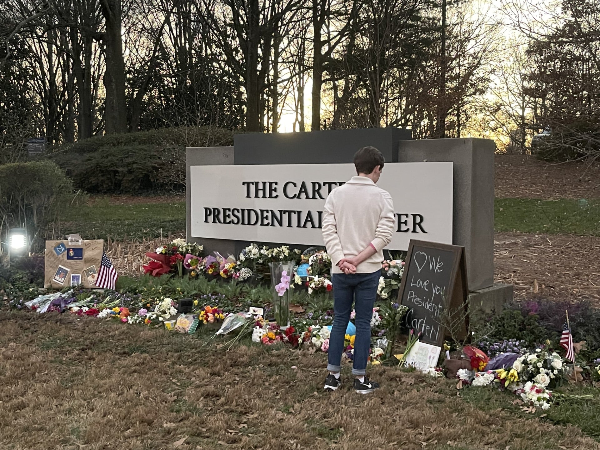 A mourner visits a memorial outside the Carter Center in Atlanta days after the death of...