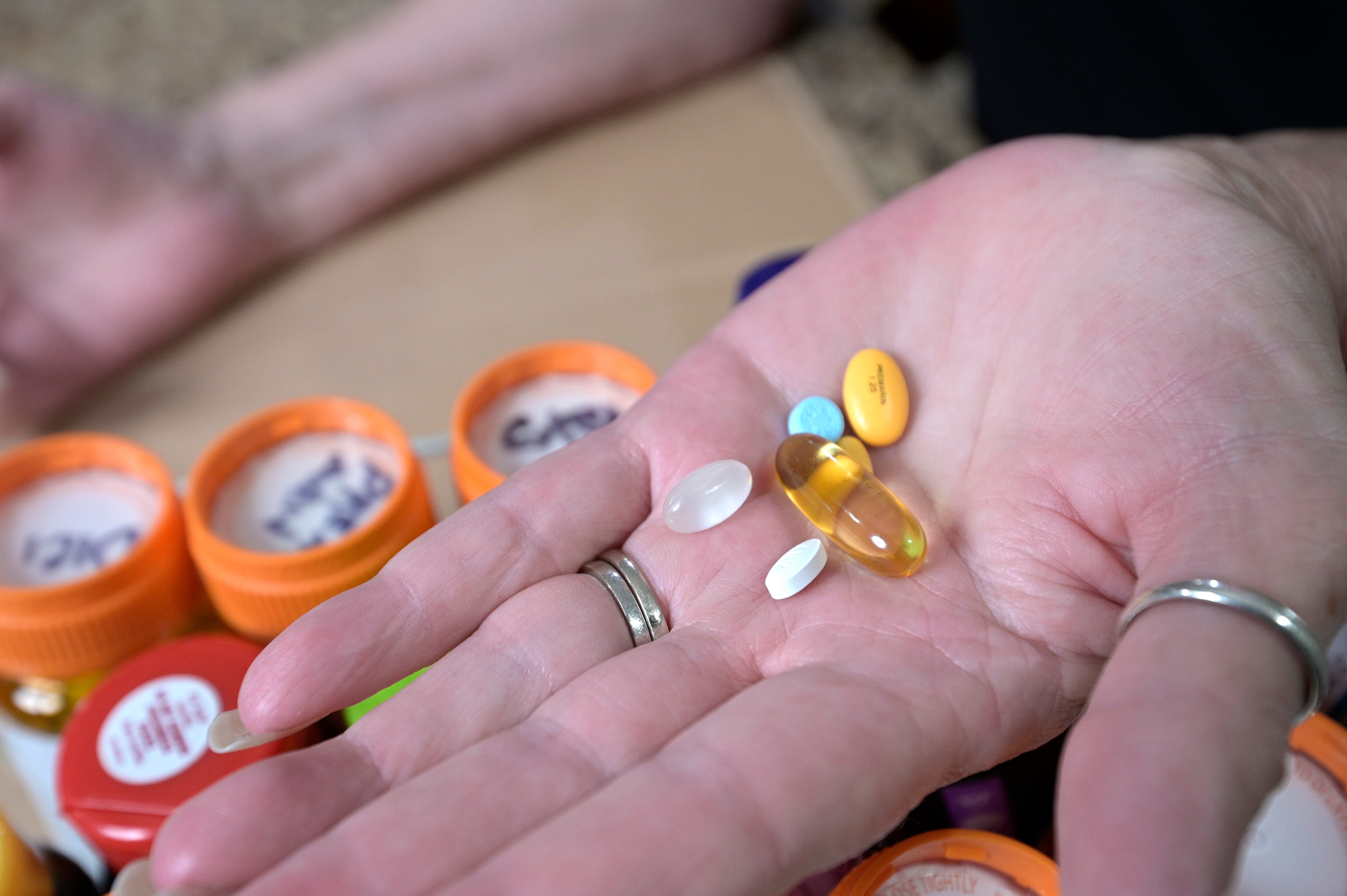 Retiree Donna Weiner shows some of the daily prescription medications that she needs and pays...