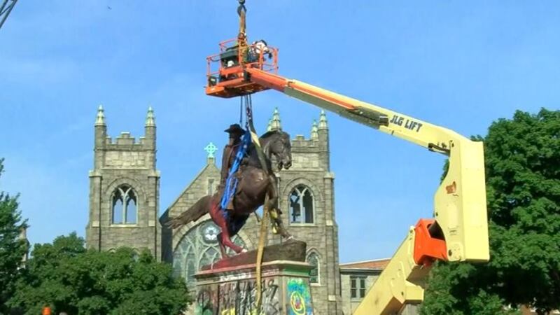 FILE - In this July 7, 2020, file photo, crews attach straps to the statue Confederate General...