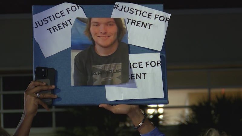 FILE PHOTO - A sign with Trenton Lehrkamp's photo at a rally in Glynn County.
