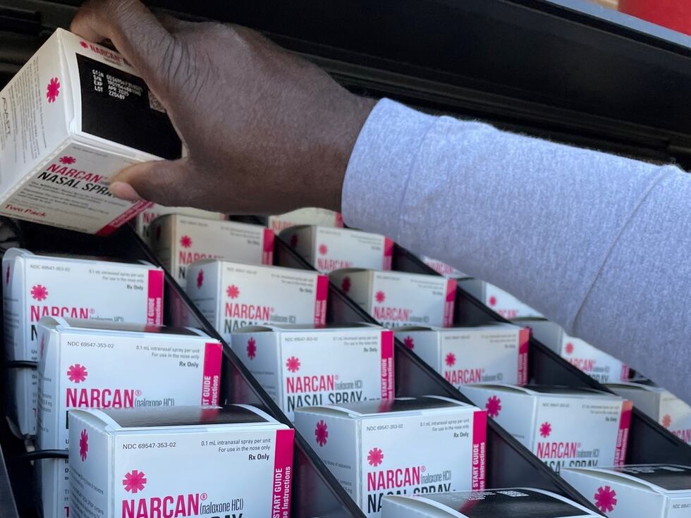 Boxes of two-doses of Narcan are lined up in the dispenser slots of a vending machine as...