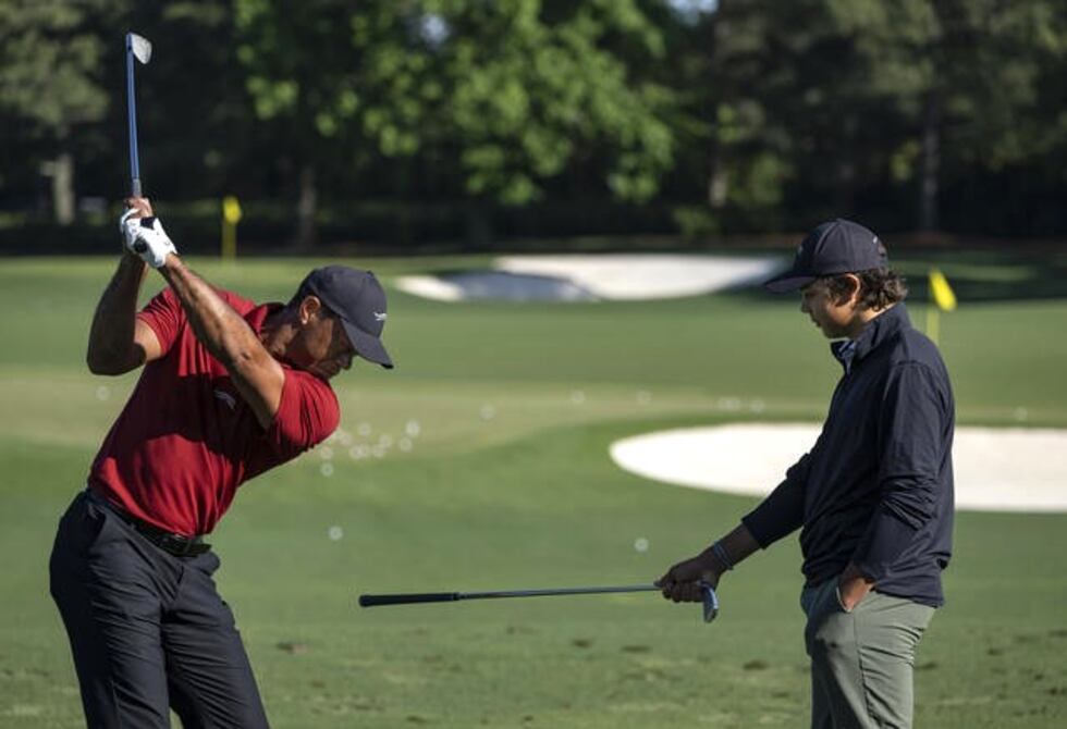 Masters champion Tiger Woods of the United States warms up on the Tournament Practice Area...
