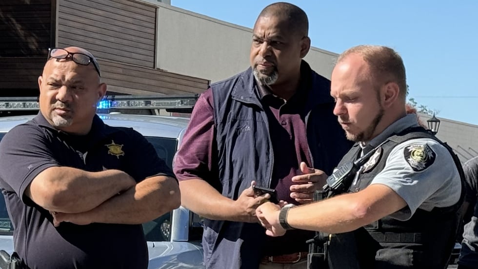 Richmond County Sheriff Richard Roundtree (center) is shown with his staff at the scene of a...