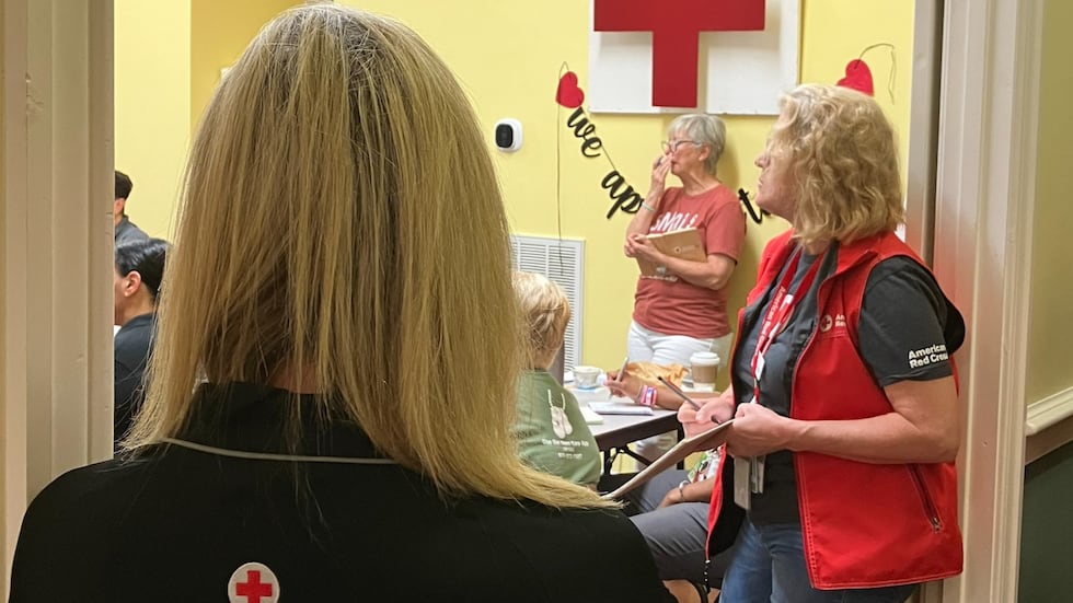 Red Cross volunteers in Augusta gather for a meeting on Aug. 6, 2024, before going oiut to...