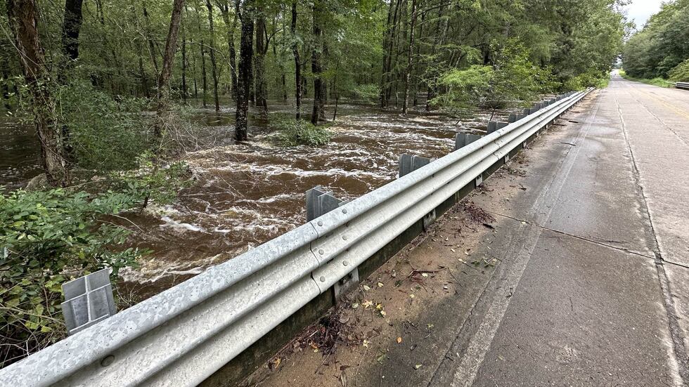 Near Newington on Wednesday, water roils alongside Creek Road after receding from the pavement.