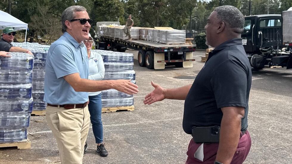 Savannah River Nuclear Solutions Central Warehousing Manager Donald Smalls, right, meets North...