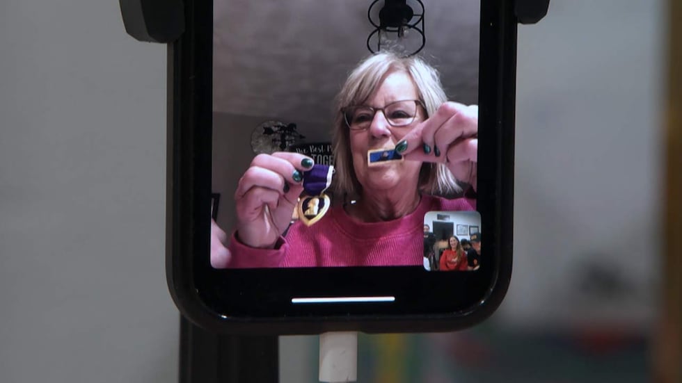 Shelly Schneider holds up military awards for her great-uncle on Facetime with the Lowcountry...