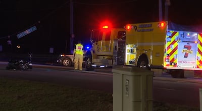 Traffic light falls on person riding a motorcycle