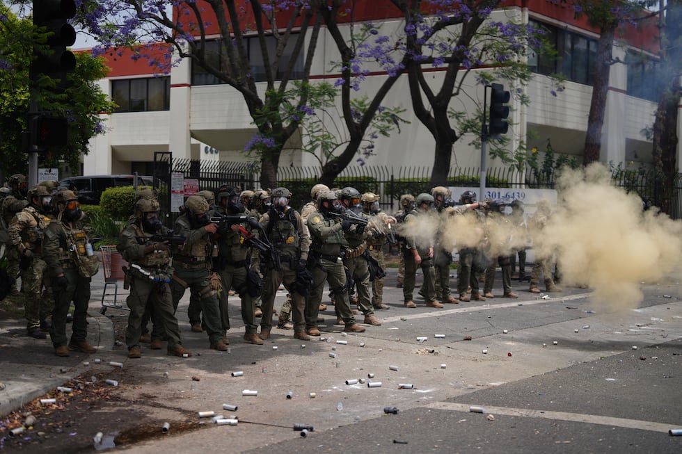 Border Patrol personnel deploy tear gas during a demonstration over the dozens detained in an...