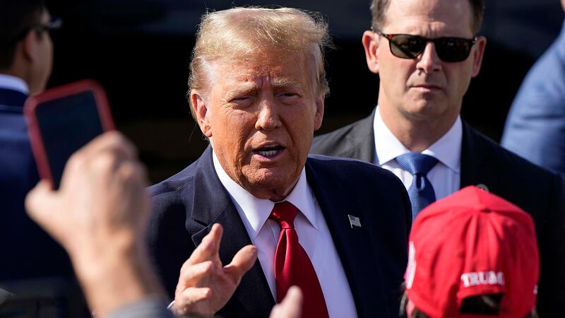 Republican presidential candidate former president Donald Trump speaks to ers after...
