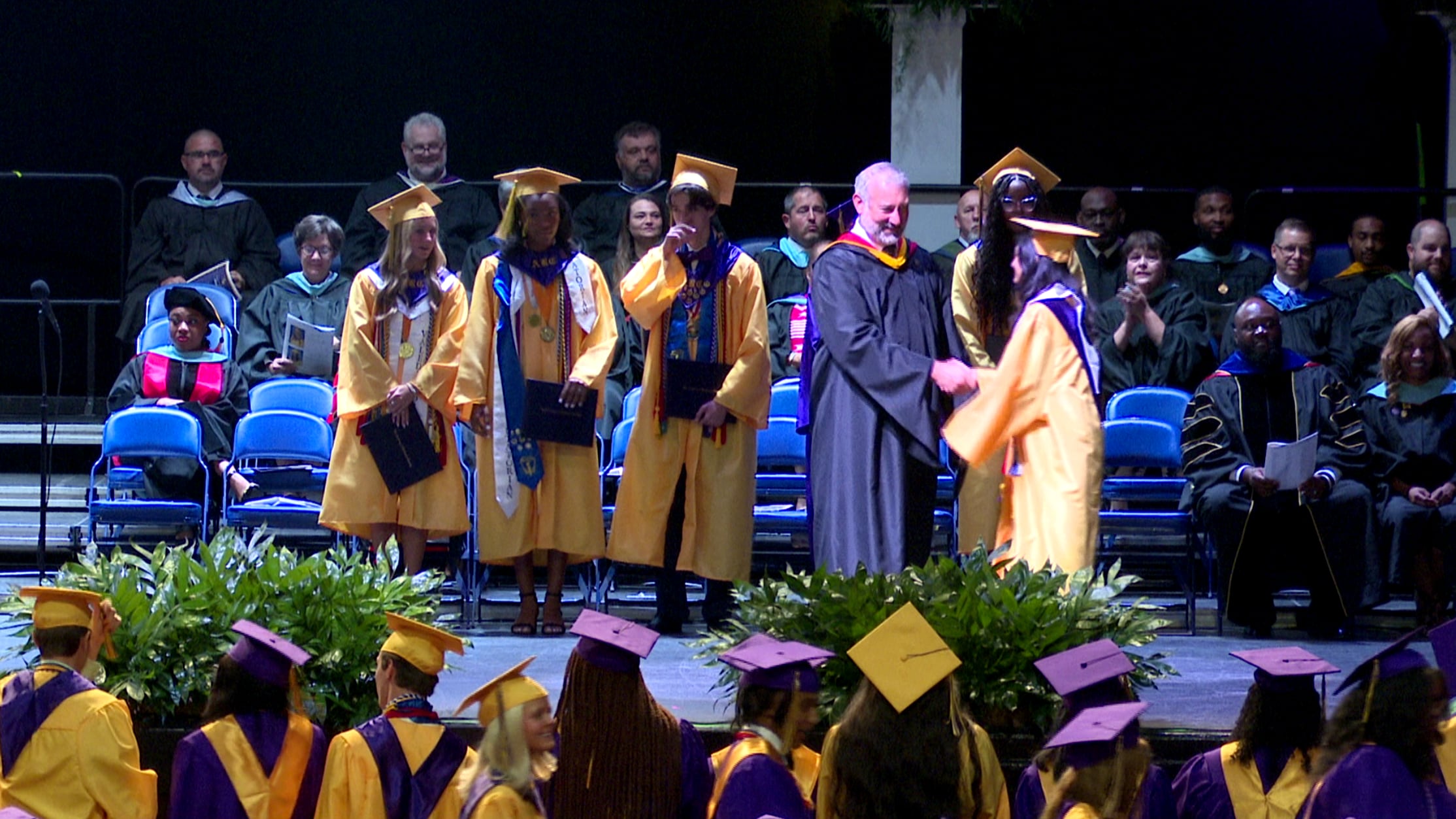 Graduates at Academy of Richmond County and Davidson Fine Arts walk across stage on Wednesday.