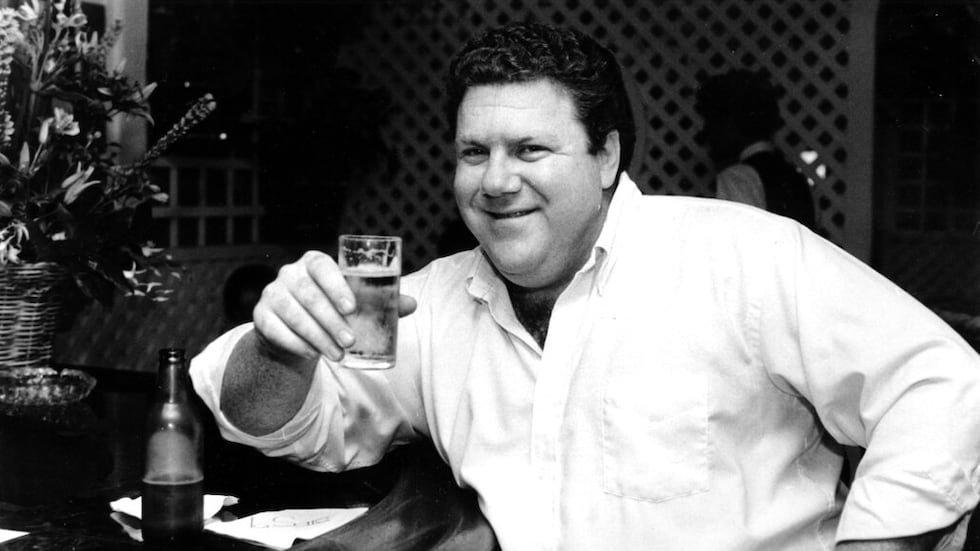 Actor George Wendt holds a glass of beer in a barroom in Los Angeles, Calif., on June 13, 1983.
