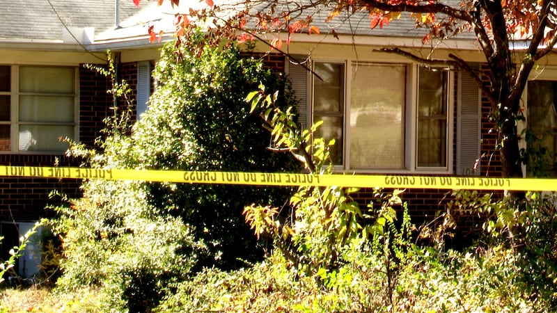 The front yard of a Jackson home is taped off after police discovered a decaying body inside...