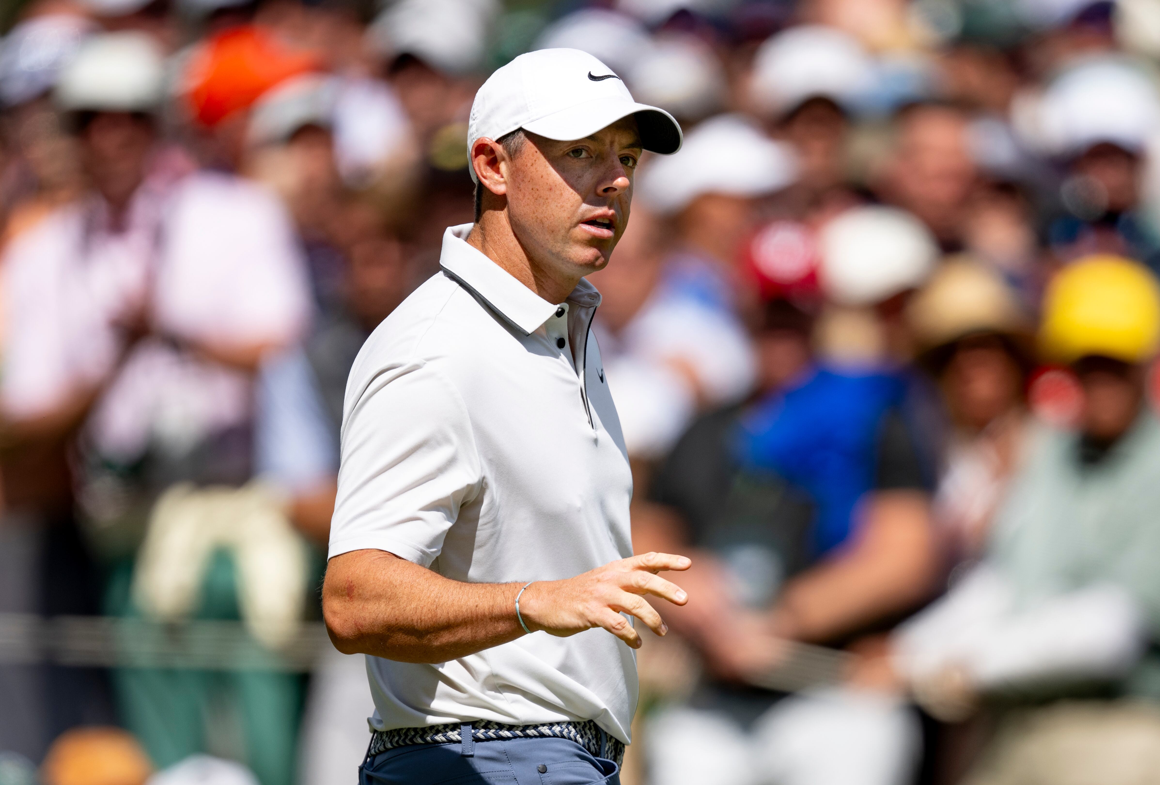 Rory McIlroy of Northern Ireland reacts to his par putt on the No. 6 green during the third...