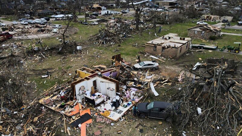 FILE - Debris is strewn around tornado damaged homes, Sunday, March 26, 2023, in Rolling Fork,...