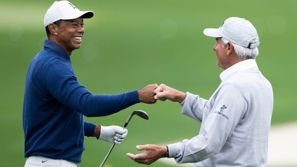 (L-R) Masters champion Tiger Woods of the United States greets Masters champion Fred Couples...