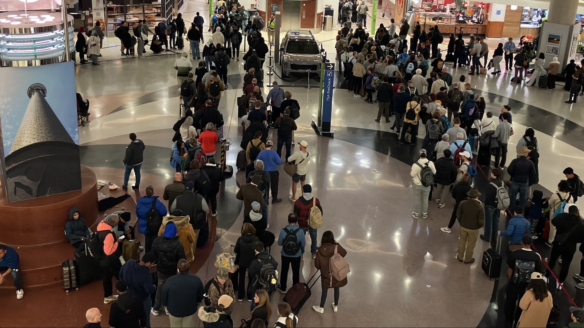 Lines are back into the atrium at Atlanta's airport on Saturday morning.