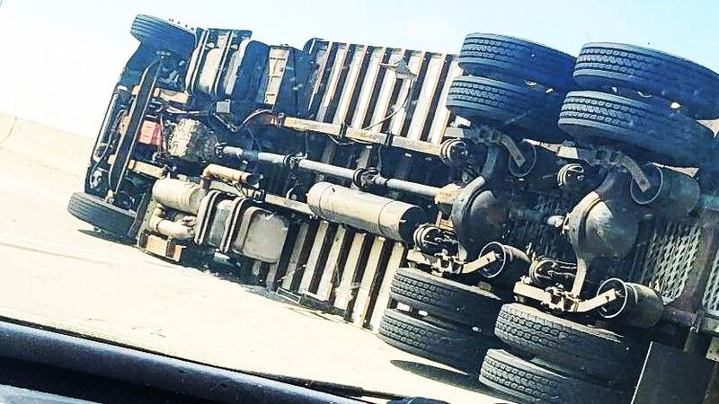 Refrigerated box truck flips onto its side near Wheeler Road exit
