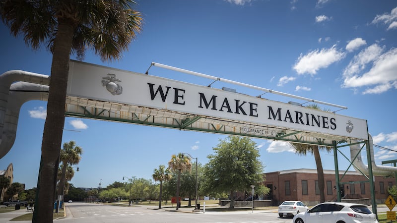 A car drives under a sign that states the sole purpose of the Marine Corps Recruiting Depot,...