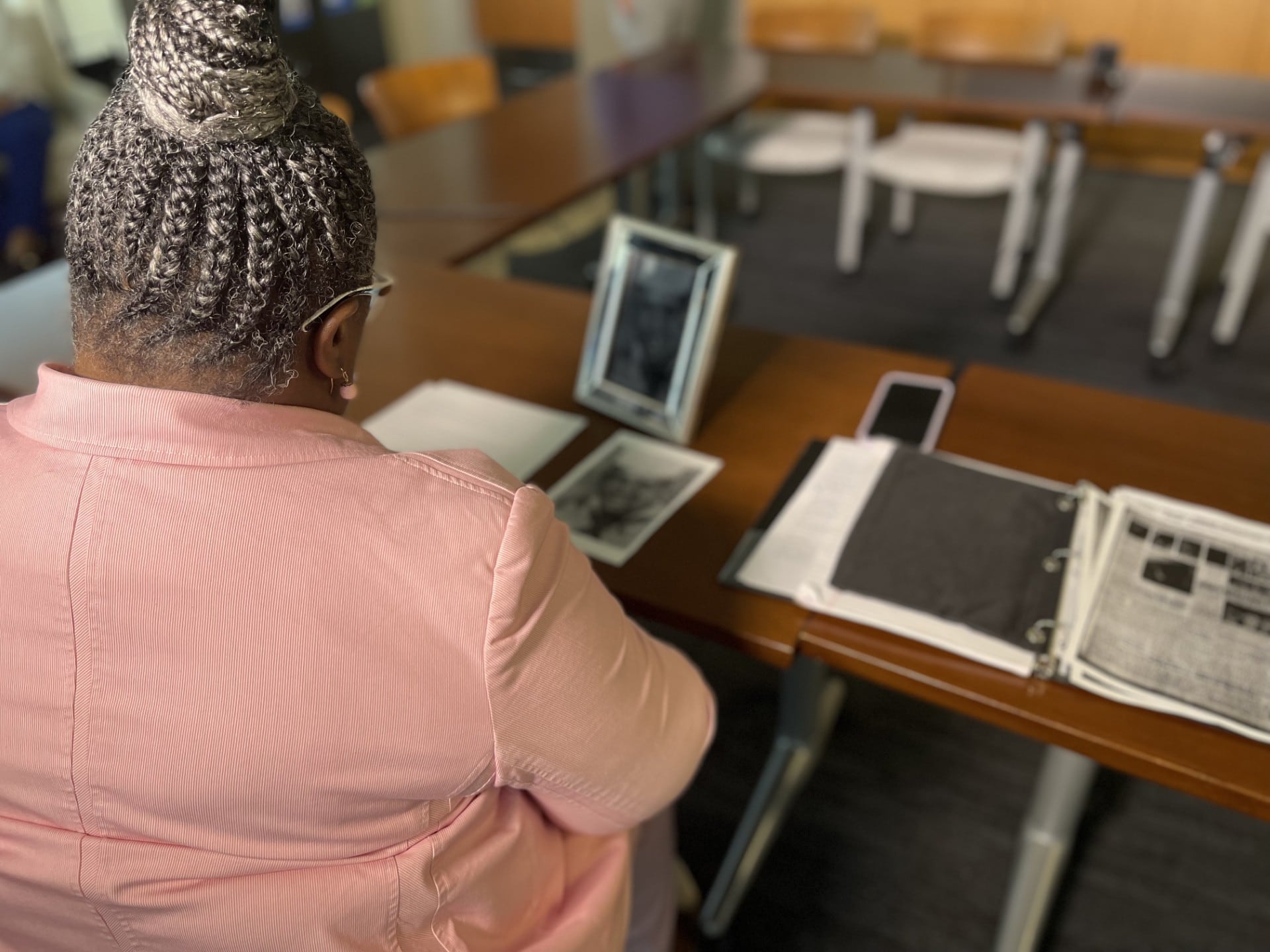 Wanda Charles, the niece of Crispin Charles, Jr., sits with new documents uncovered by the...