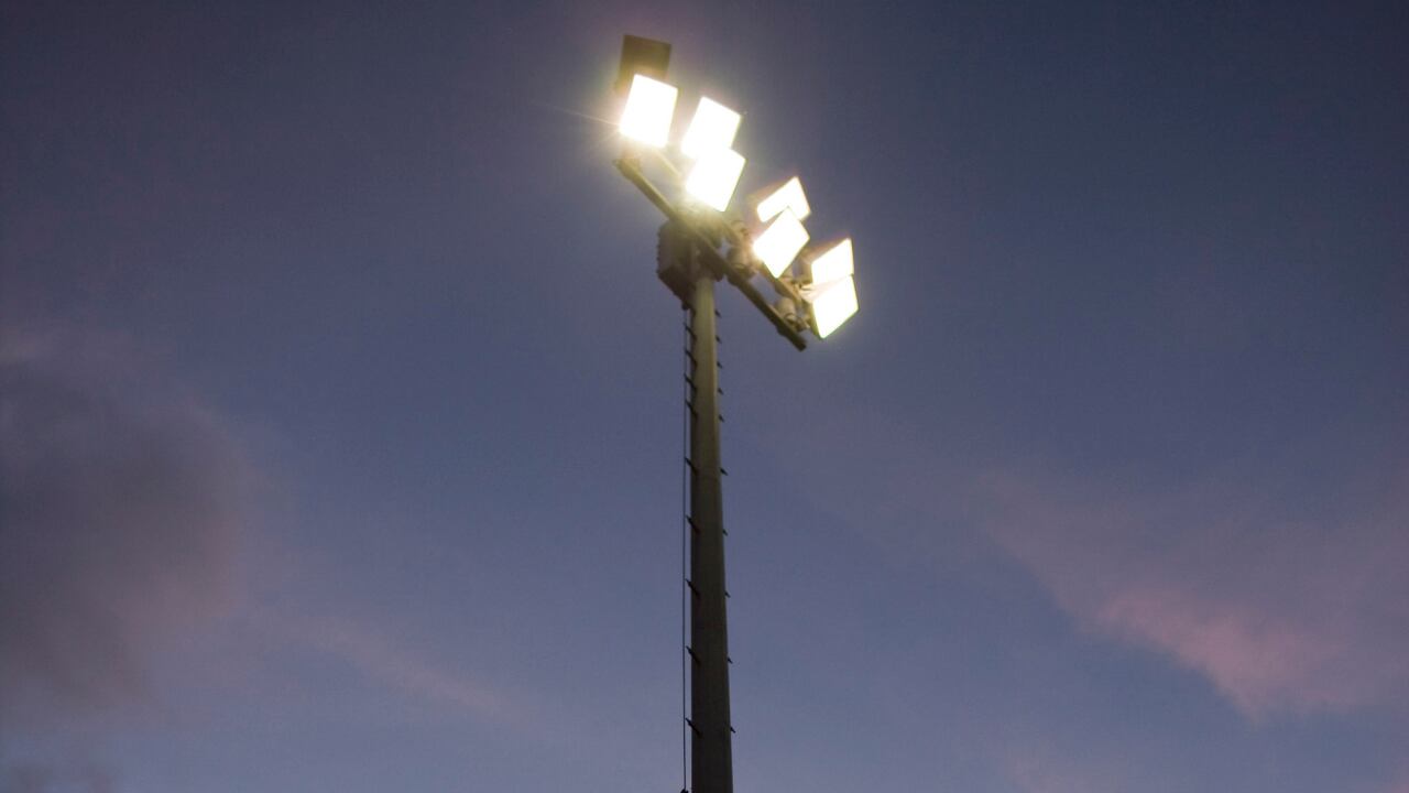 Stadium lights over a high school football field.