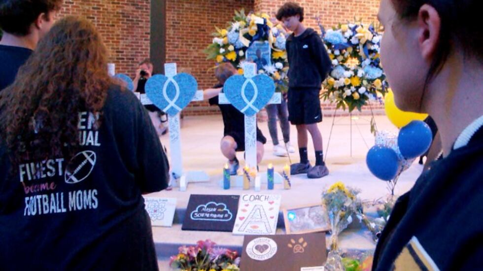 An Apalachee High School senior leaves paintings for the victims of Wednesday's shootings