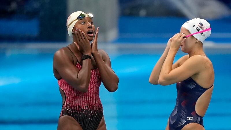 FILE - Simone Manuel of the United States, left, reacts with teammate Katie McLaughlin, right,...