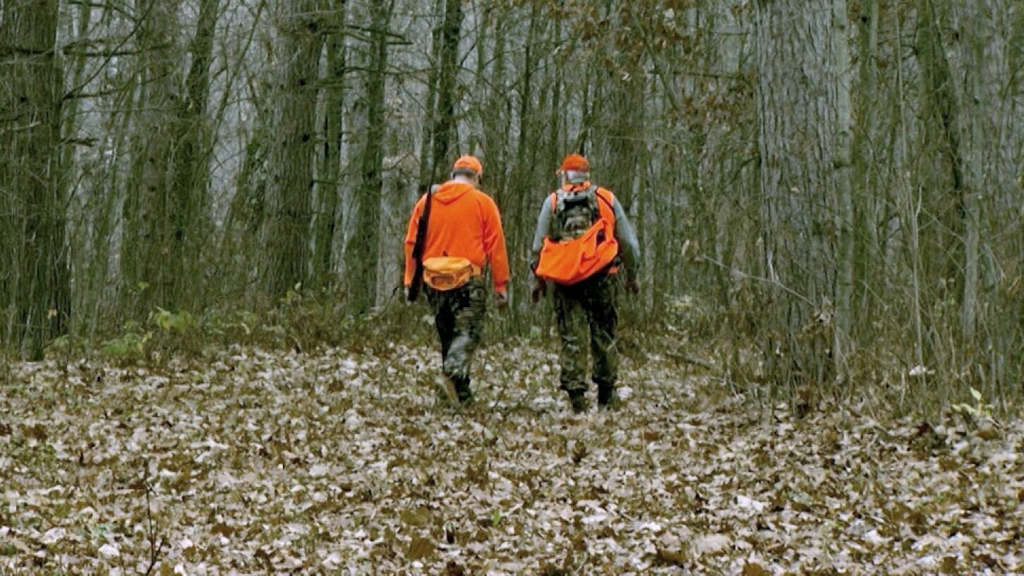 FILE — Two people walk into a wooded area on a hunting expedition in Minnesota.