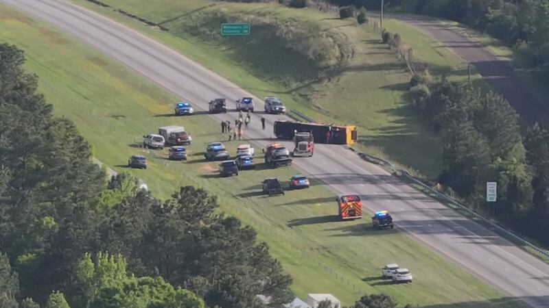 At least one person died after a school bus from Lexington County, S.C., overturned on I-77 in...