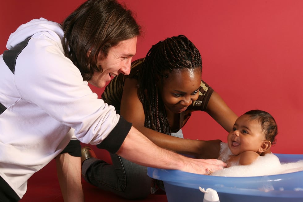 20-year-old soccer star Lionel Messi helps to bathe Lamine Yamal, who was merely six months...