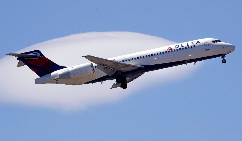 FILE- In this May 24, 2018, file photo a Delta Air Lines enger jet plane, a Boeing 717-200...