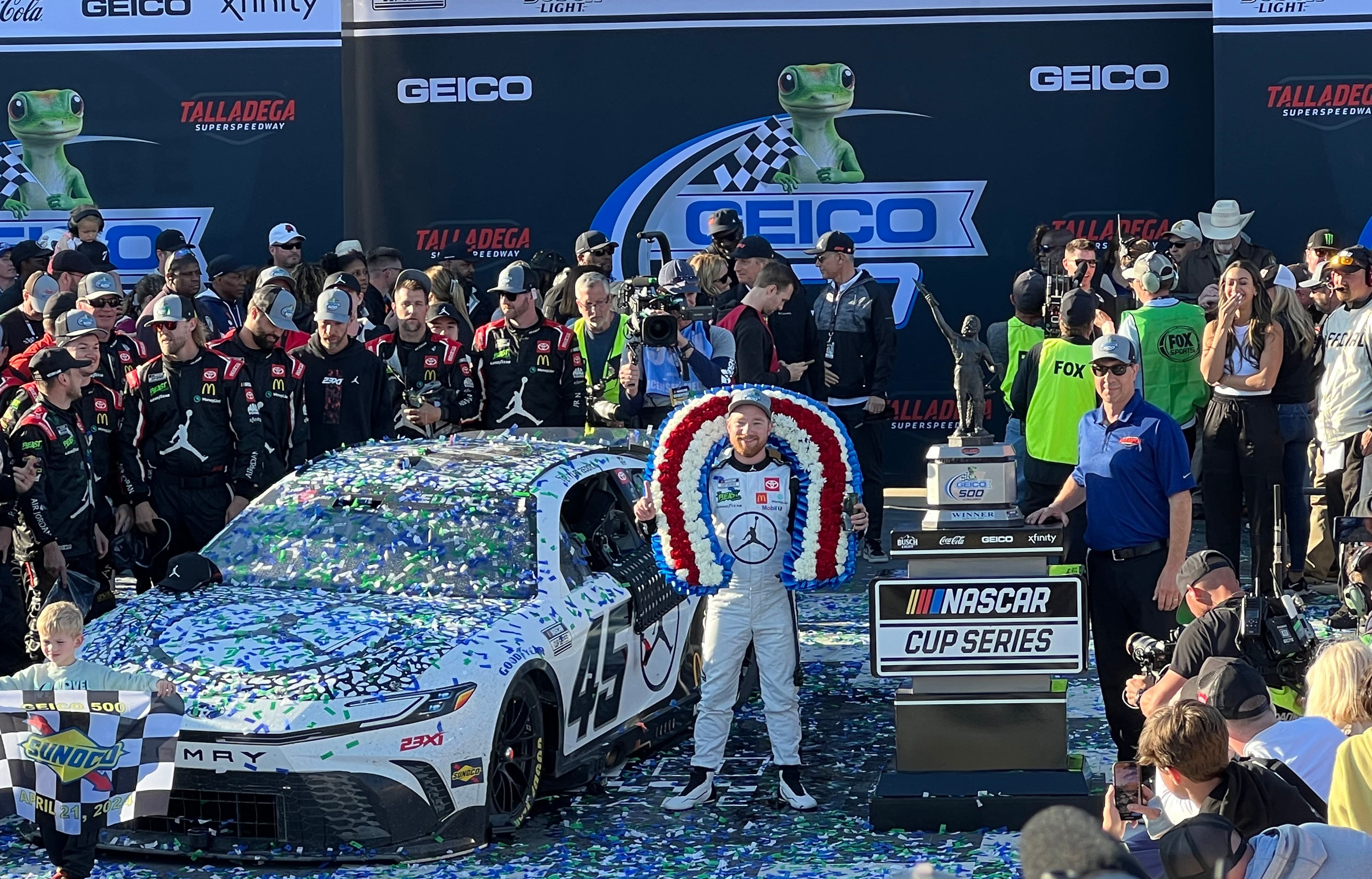 Tyler Reddick stands in victory lane after winning the 2024 Geico 500 at Talladega Superspeedway