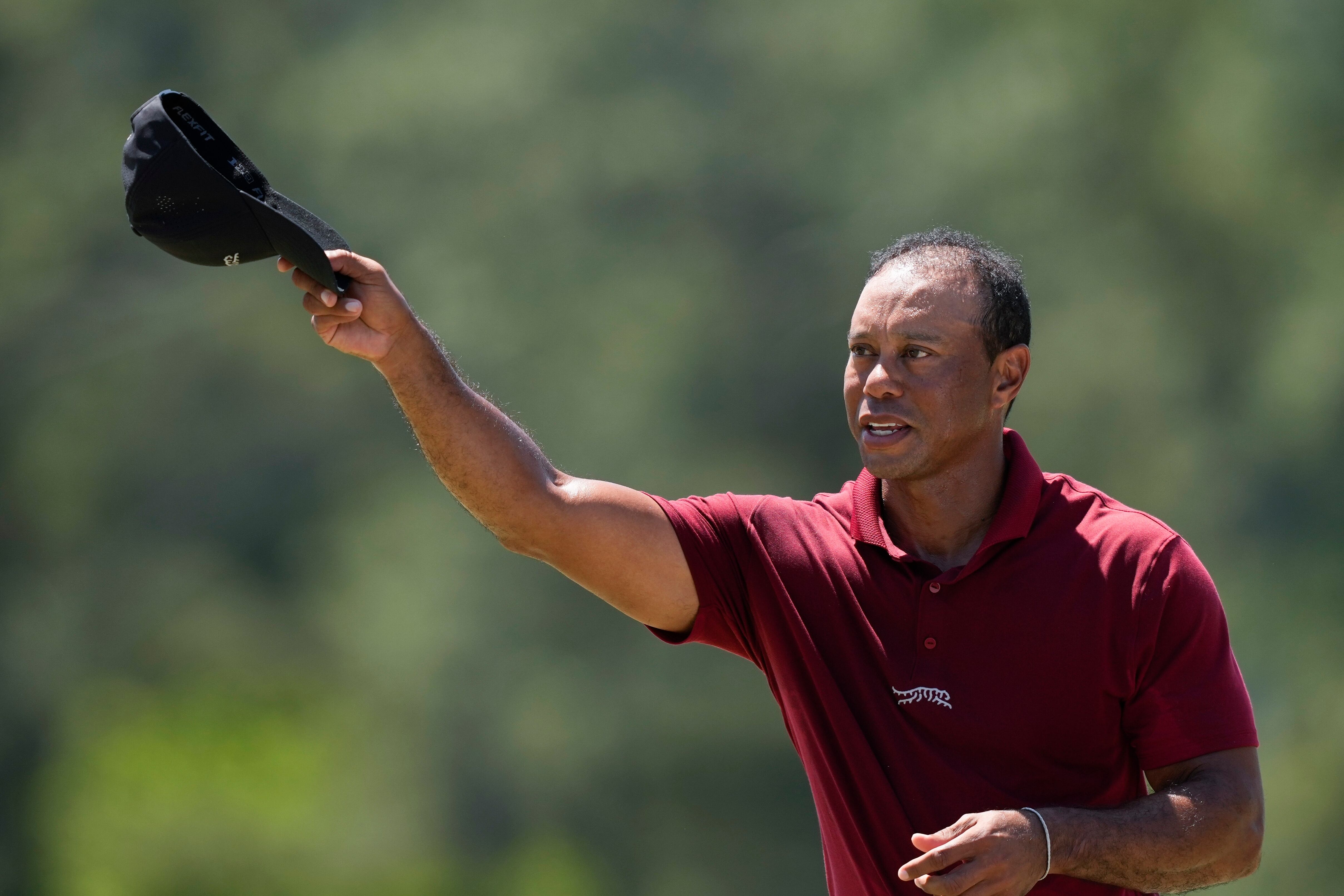 Tiger Woods waves after his final round at the Masters golf tournament at Augusta National...