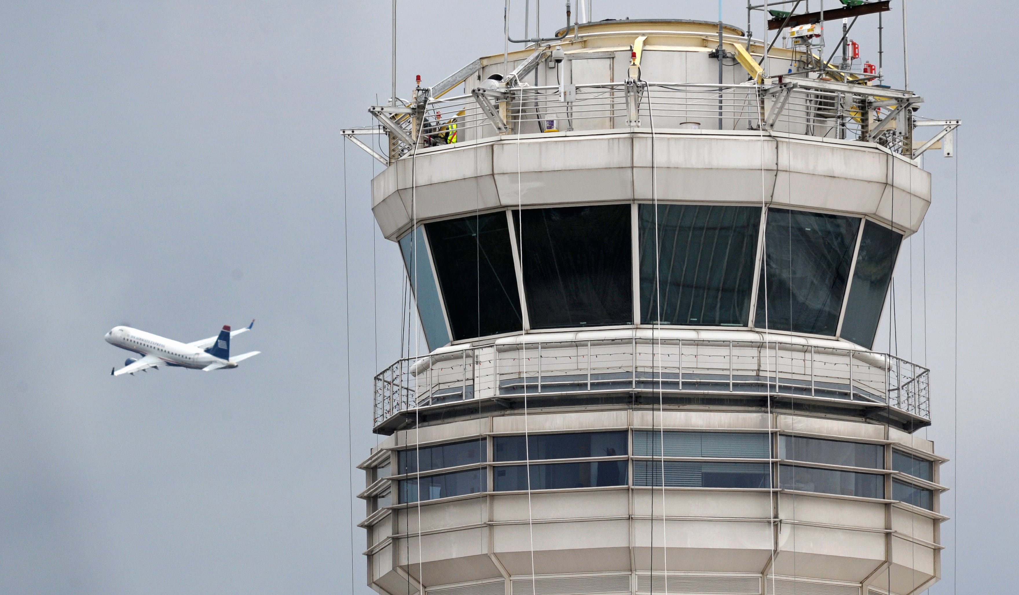 A enger jet flies past the FAA control tower at Washington's Ronald Reagan National...