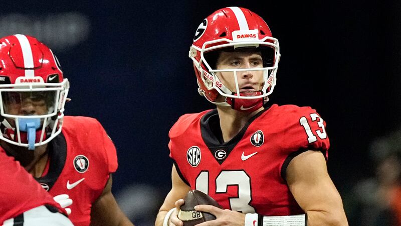 FILE - Georgia quarterback Stetson Bennett (13) looks for an open receiver in the first half...