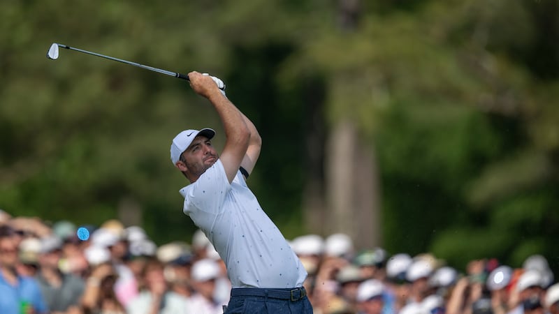 Masters champion Scottie Scheffler of the United States plays a stroke from the No. 12 tee...