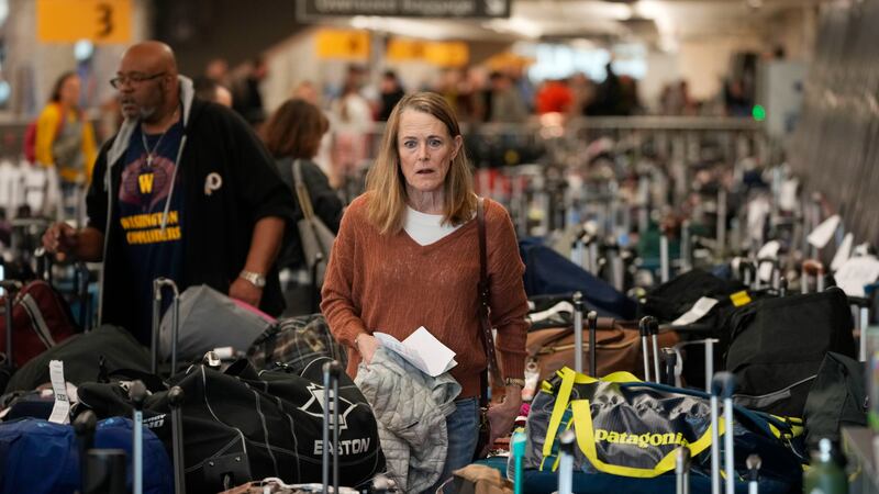 A traveler wades through the field of unclaimed bags at the Southwest Airlines luggage...