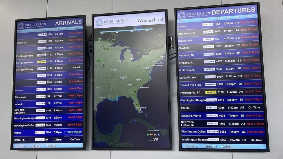 Flight status monitors inside the Charleston International Airport show the extent of delayed...