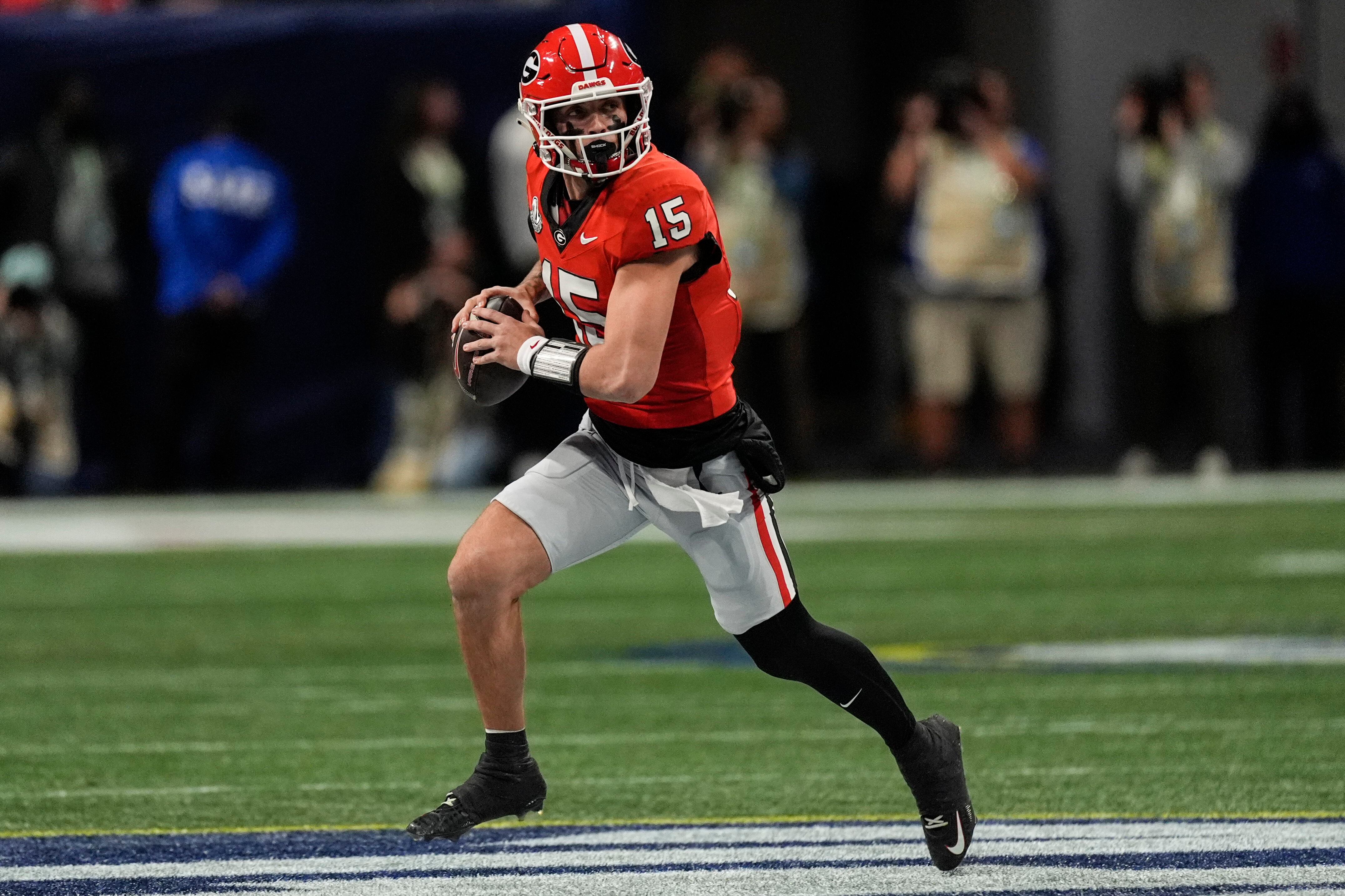 Georgia quarterback Carson Beck (15) runs out of the pocket against Texas during the first...