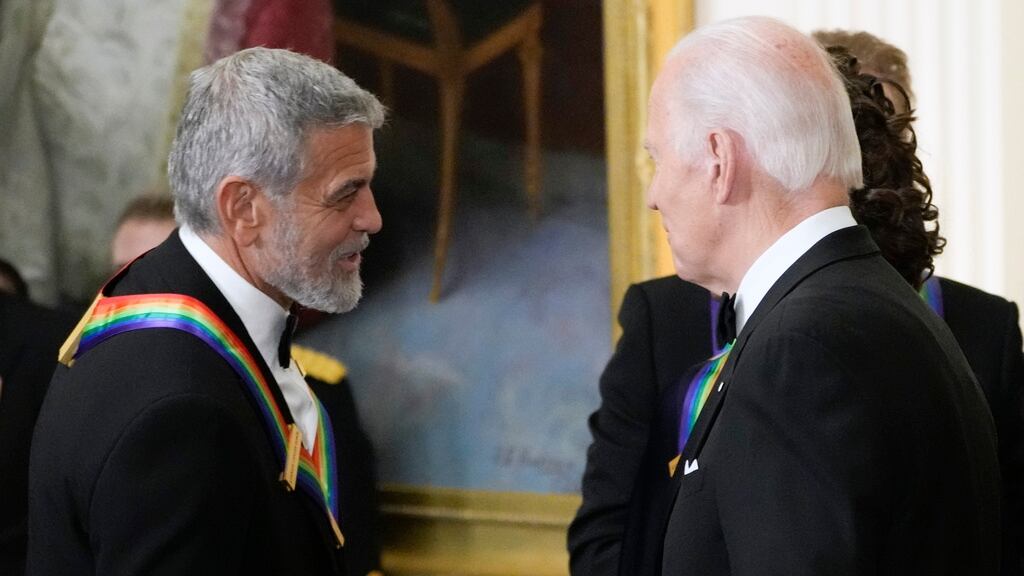 FILE - President Joe Biden shakes hands with George Clooney during the Kennedy Center honorees...