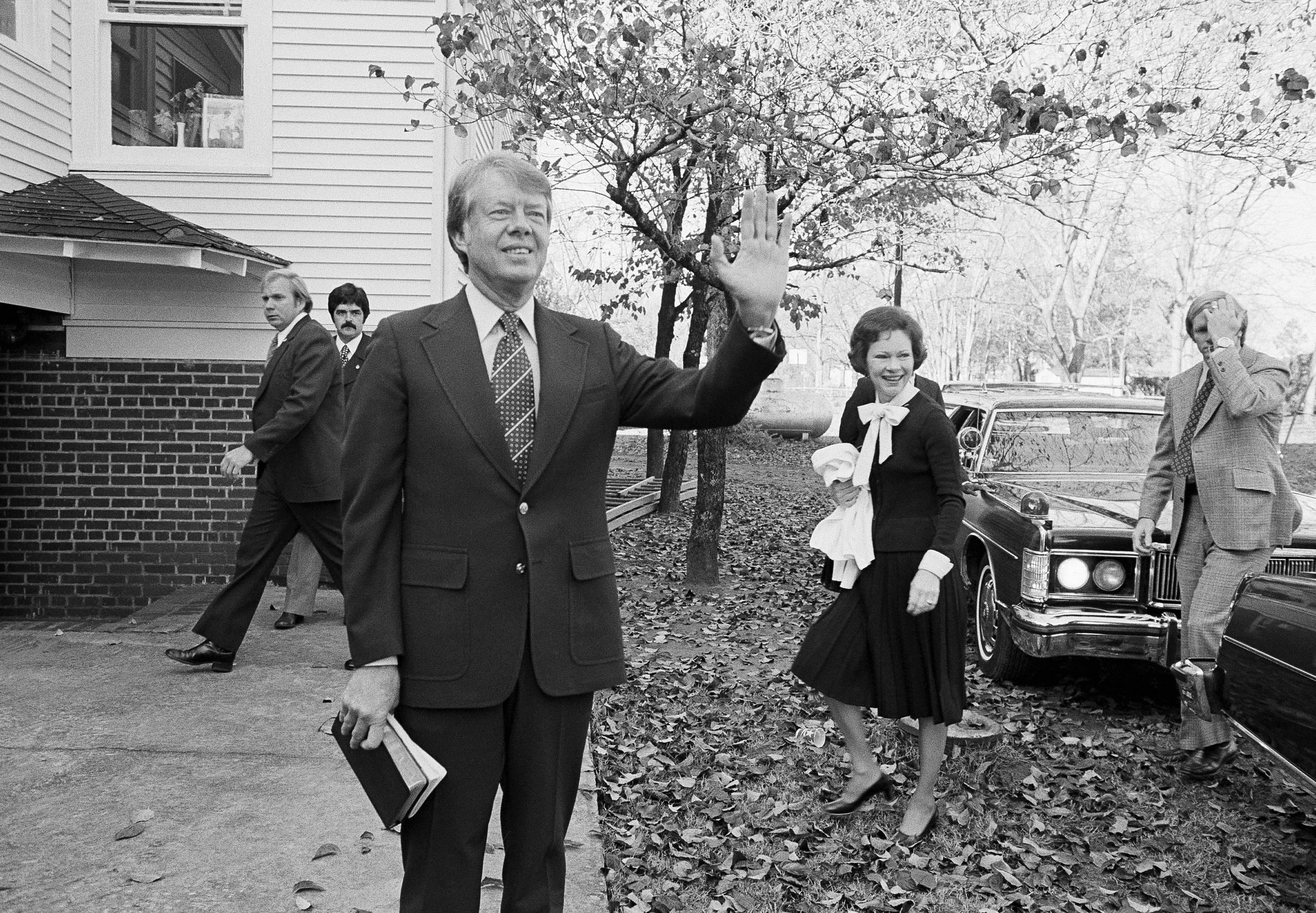 FILE - President-elect Jimmy Carter waves to the crowd as he and his wife Rosalynn arrive at...